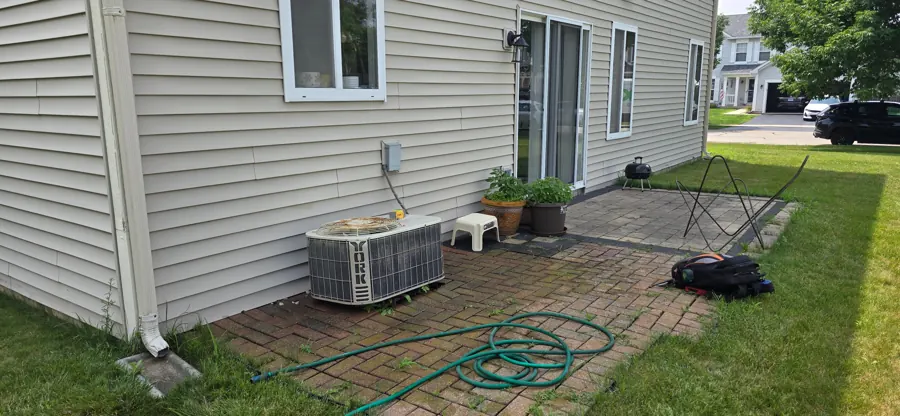 Two new AC condensers installed on composite pads by Heavy Duty Heating and Cooling