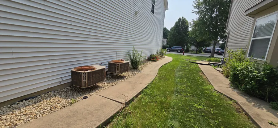 Side-yard condenser placement with clean line-set runs — our work