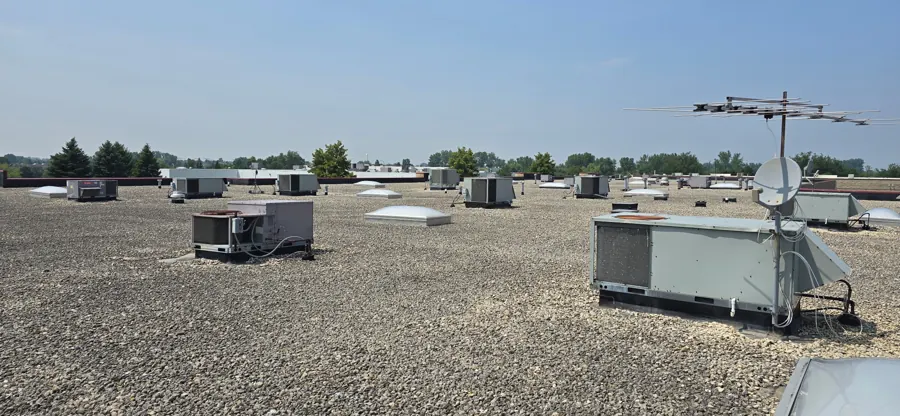 Packaged rooftop HVAC units on a commercial flat roof — serviced by Heavy Duty Heating and Cooling