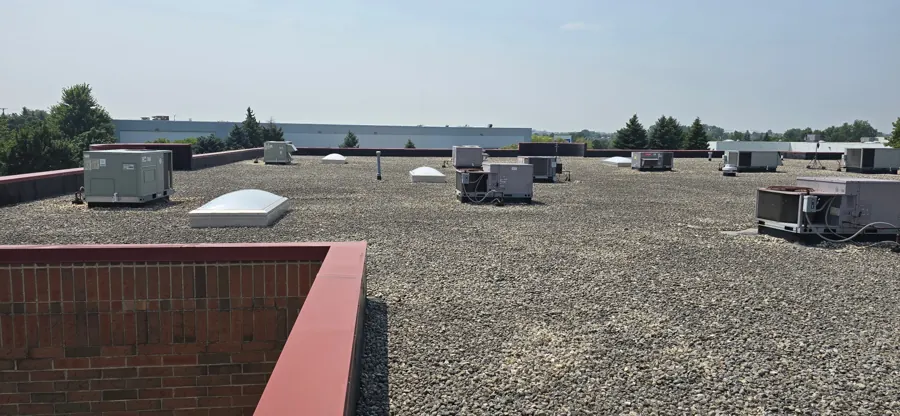 Multiple rooftop units on a commercial flat roof — our service call